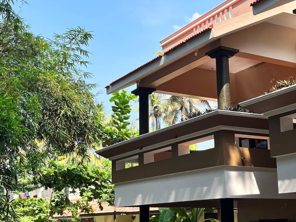 a building with balconies on the side of it at BAVA Lalitha Retreat Center Varkala in Varkala