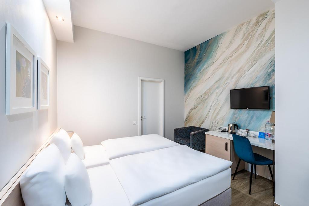 Postel nebo postele na pokoji v ubytování Atrium Fashion Hotel