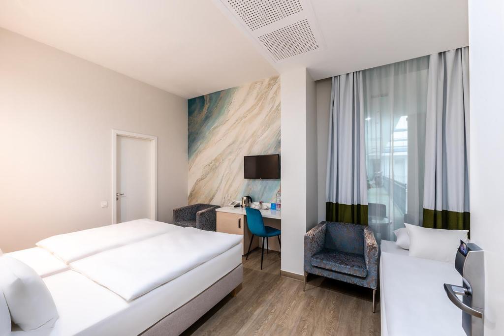 Postel nebo postele na pokoji v ubytování Atrium Fashion Hotel
