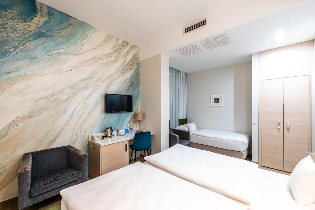 Postel nebo postele na pokoji v ubytování Atrium Fashion Hotel