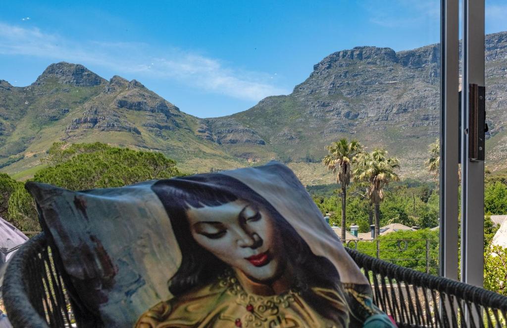 a painting of a woman with mountains in the background at Chic Studio Apartment Mountain views Gardens in Cape Town