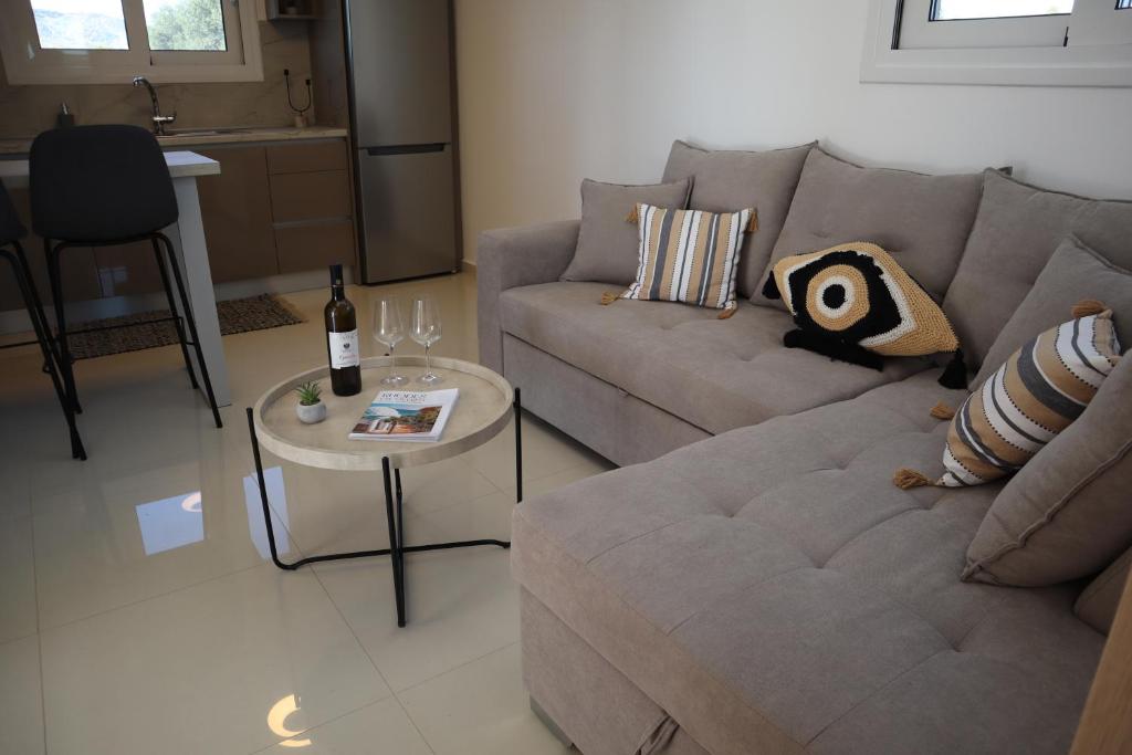 a living room with a couch and a table with a bottle of wine at Merelia Luxury Guesthouse in Haraki