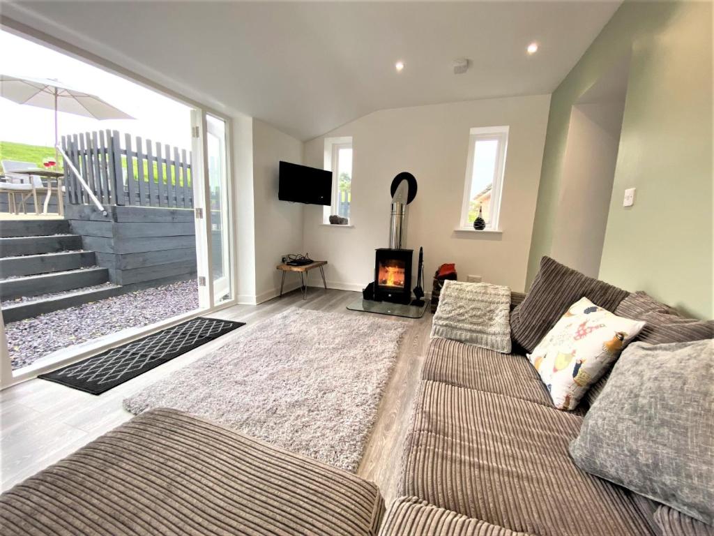 a living room with a couch and a fireplace at 2 Bed in Wrexham 76399 in Coedpoeth