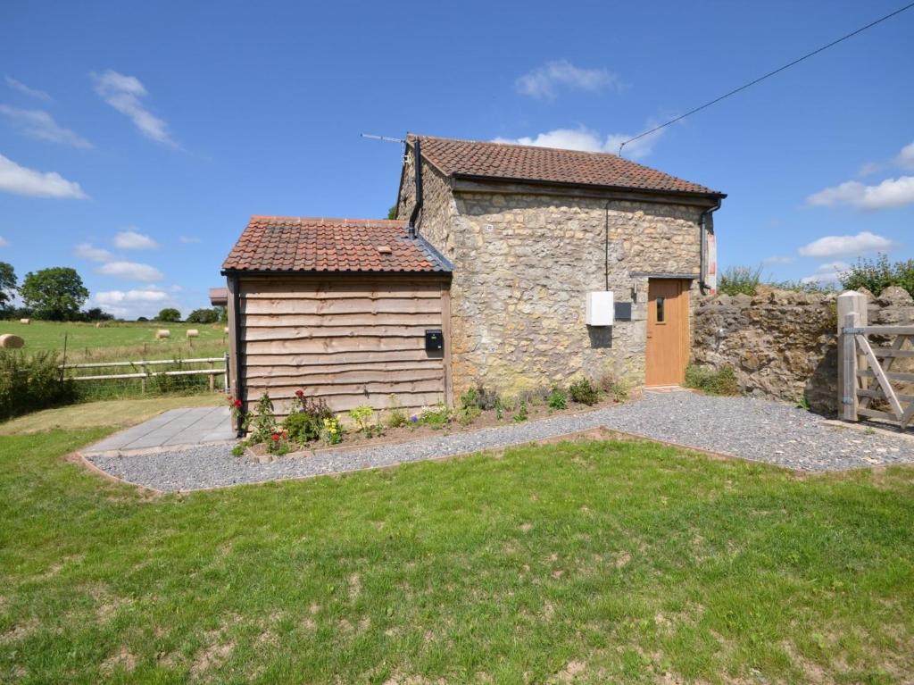 a small stone building with a gate and a yard at 2 Bed in Bristol 75697 in Bristol