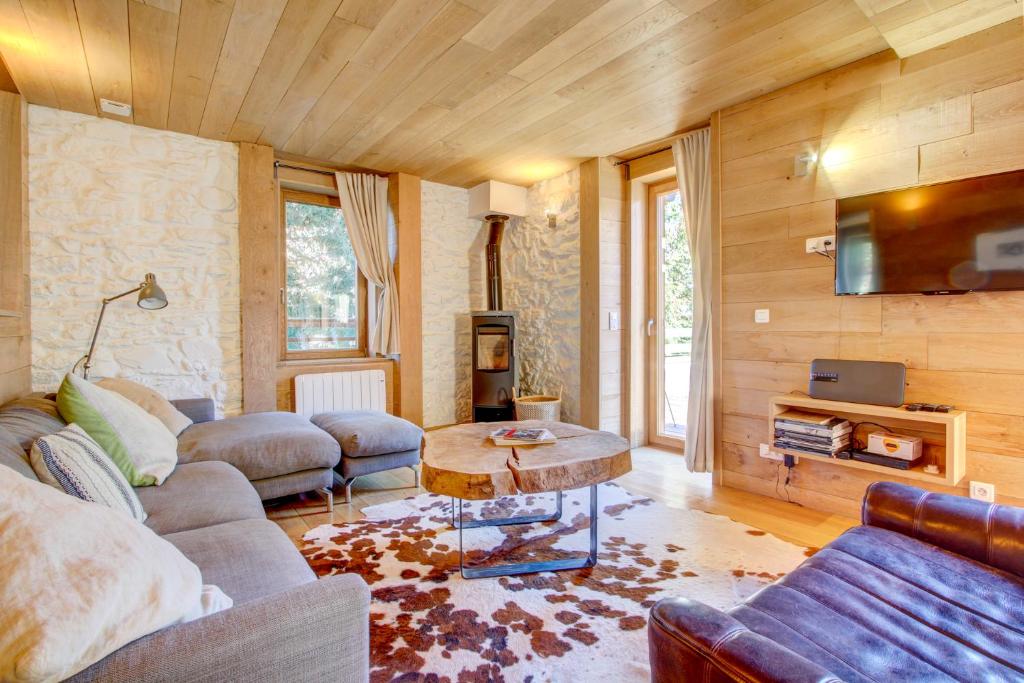 a living room with a couch and a table at AUBERGE 1 in Morzine