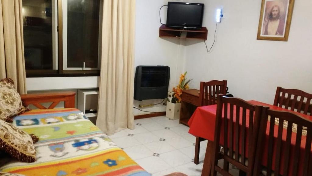 a bedroom with a bed and a tv in a room at Departamento Las Grutas in Las Grutas