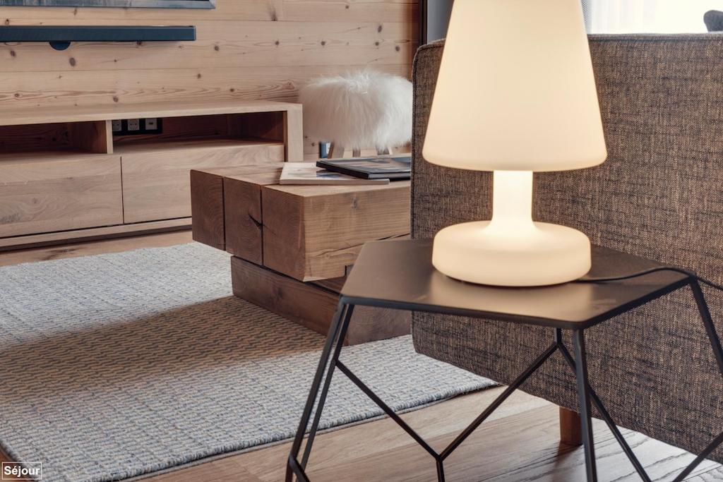 a lamp sitting on a table in a living room at Hôtel Avancher in Val-d'Isère