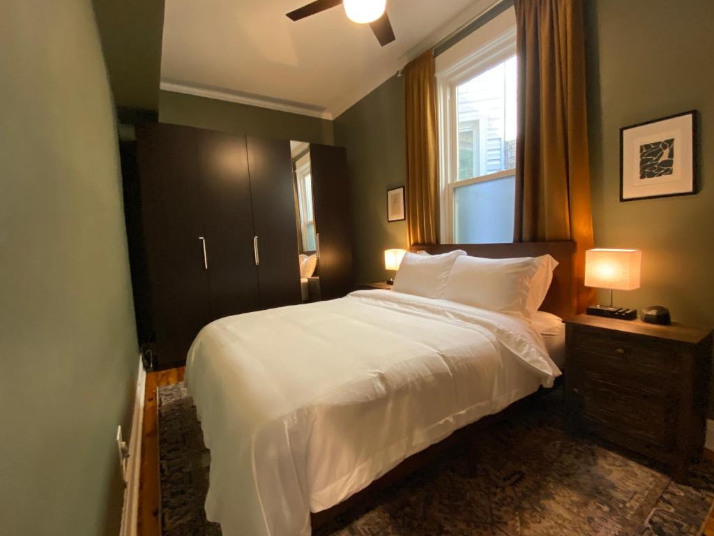a bedroom with a white bed and a window at Elegant Hideaway in the Heart of Andersonville in Chicago