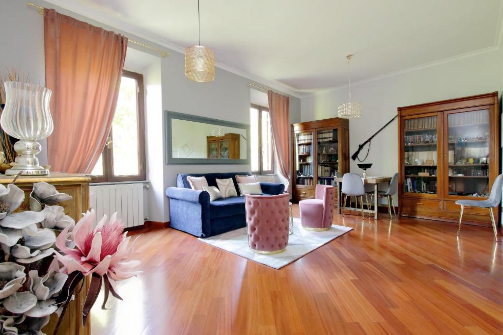 a living room with a blue couch and a table at Beautiful apartment with amazing Rooftop&Jacuzzi in Rome