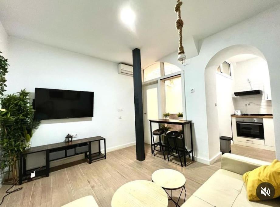a living room with a flat screen tv on a wall at Puerto Amazonas apartamento con jacuzzi privado in El Puerto de Santa María