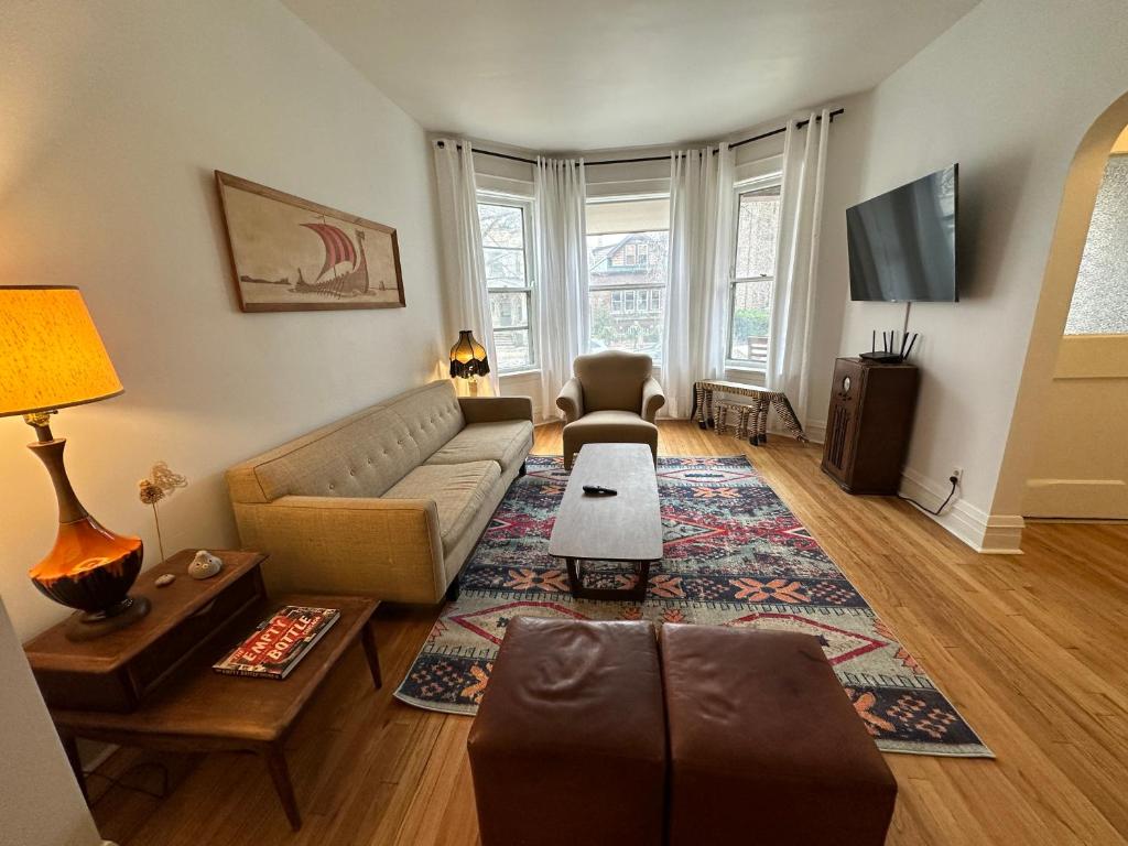 a living room with a couch and a table at Logan Square Hideaway in Chicago