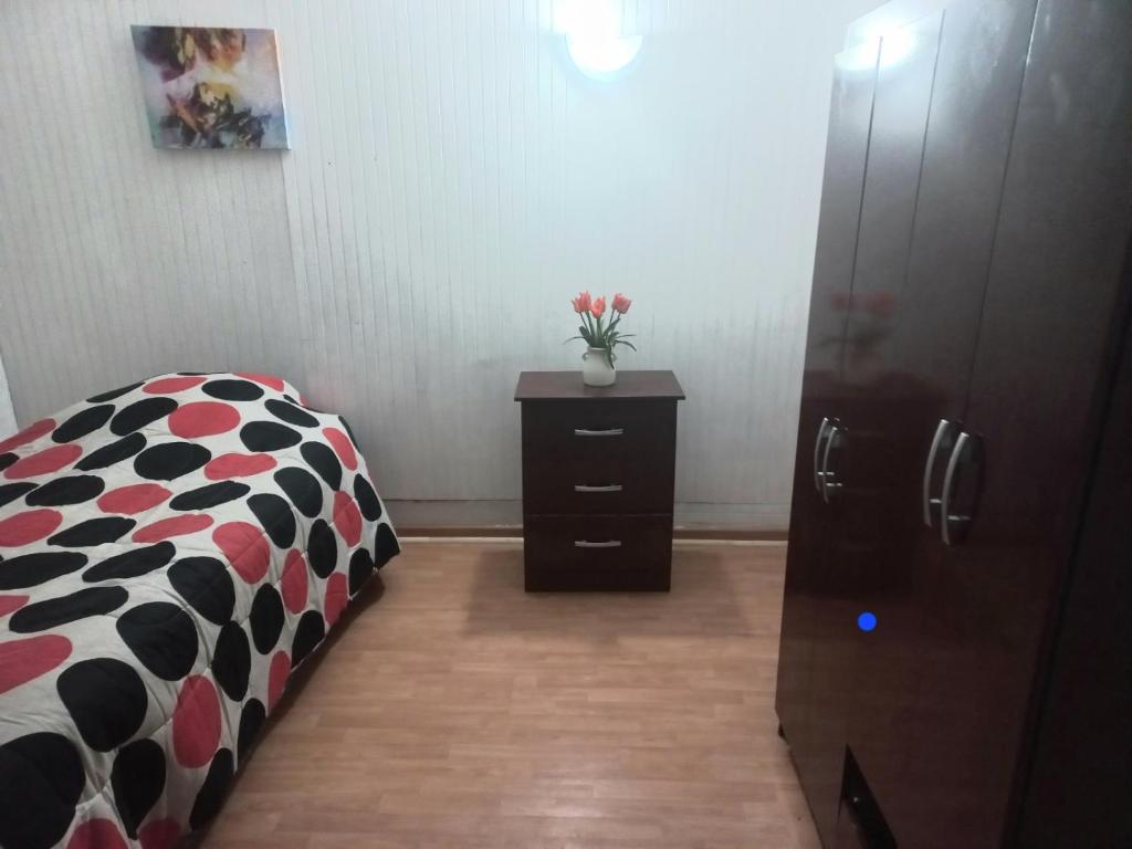 a bedroom with a bed and a dresser and a cabinet at Health & Wisdom in Antofagasta