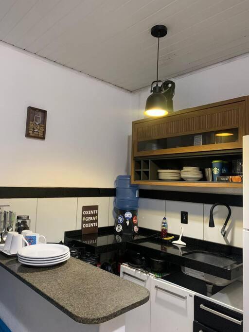 a kitchen with a counter top with plates on it at Casa próximo ao aeroporto in Rio Largo