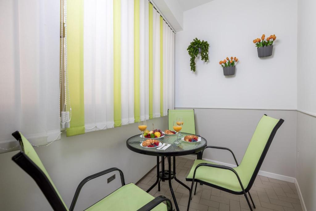 a small table and chairs in a room at Apartment City flower in Rijeka