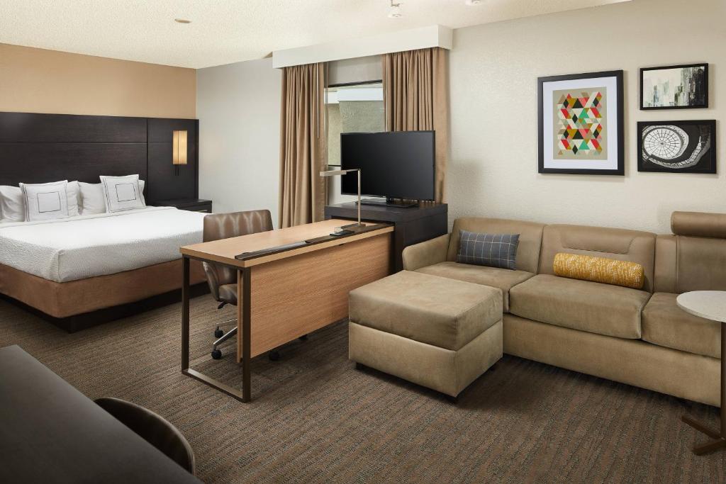 a hotel room with a bed and a desk and a couch at Residence Inn Irvine Spectrum in Irvine
