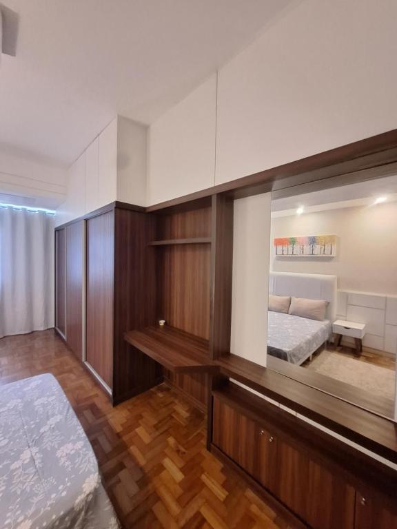 a bedroom with a bed and a large mirror at Bela Vista Copacabana in Rio de Janeiro