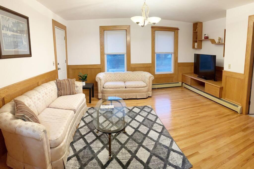 a living room with two couches and a tv at 17 Cozy&Spacious 3 bedroom home in Malden in Malden