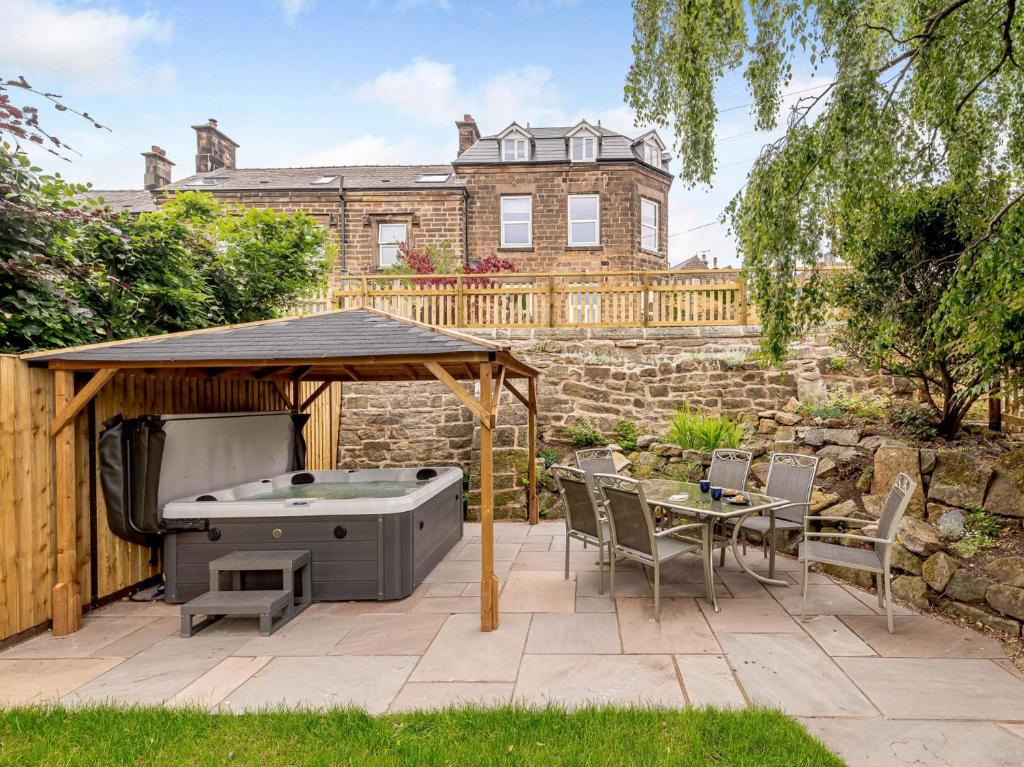 a patio with a hot tub and a gazebo at 4 Bed in Matlock 88011 in Matlock