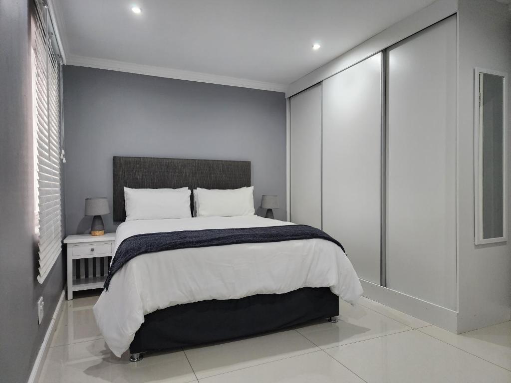 a bedroom with a large bed and a window at Vusi's Guesthouse in Durban