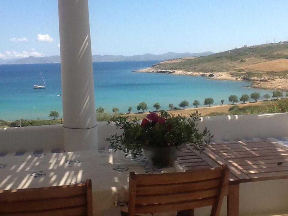 a table with a vase of flowers on top of a balcony at casa koklakura in Lipsoi