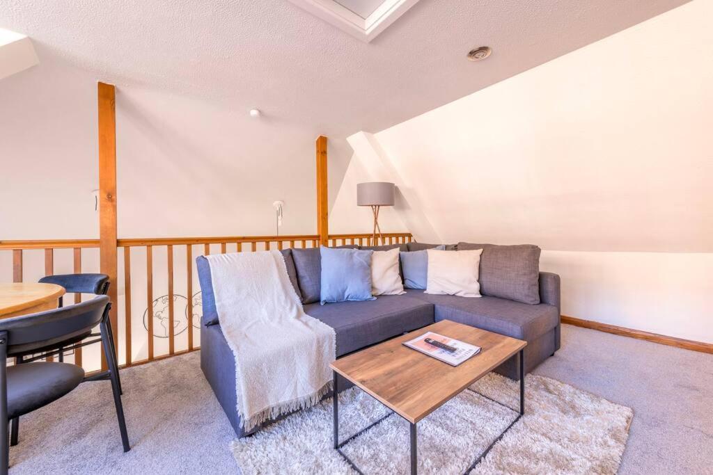 a living room with a couch and a table at Centralised Admiralty Terrace with FREE PARKING by Prescott Apartments in Bristol