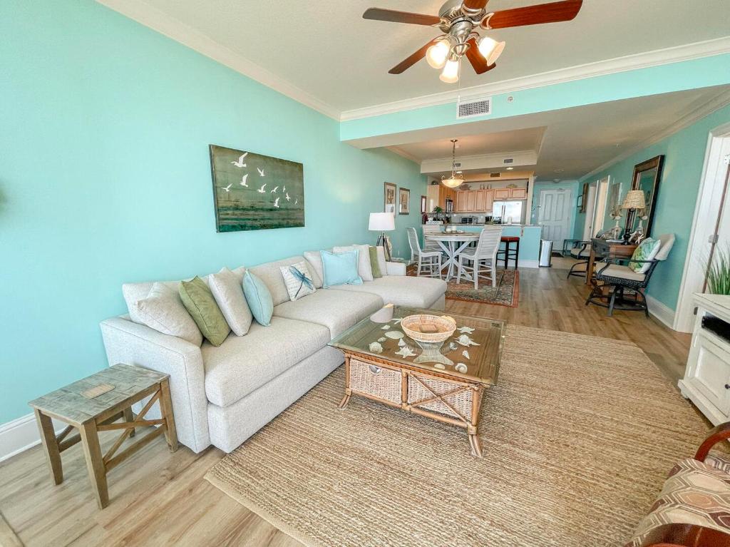 ein Wohnzimmer mit Sofa und Tisch in der Unterkunft 604 Holiday Isle Beach Life in Dauphin Island