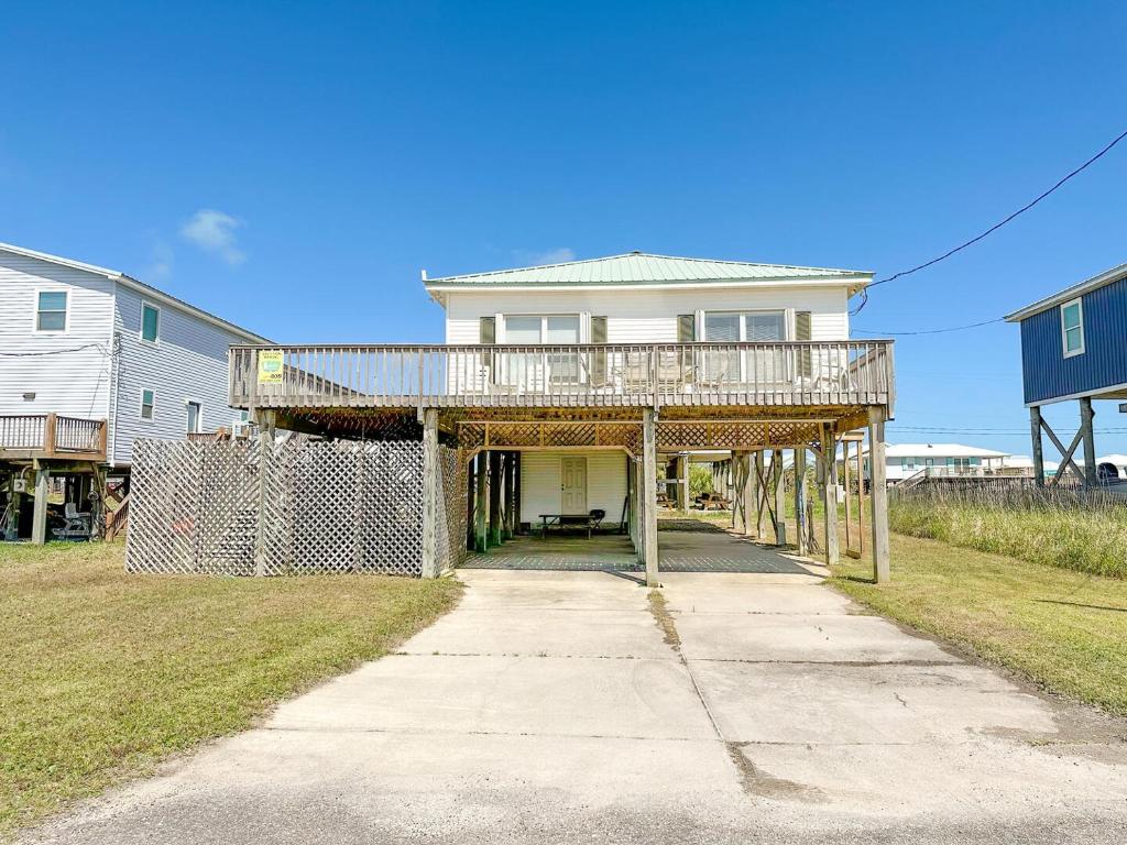 a house with a wrap around porch with a deck at 039 Two Views in Dauphin Island