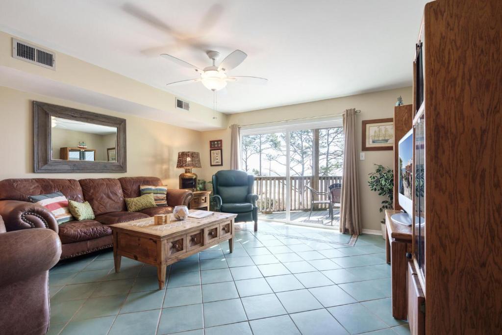 ein Wohnzimmer mit Sofa und Tisch in der Unterkunft 037 Sandcastle 6D in Dauphin Island