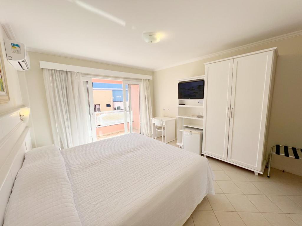 Cama ou camas em um quarto em Pousada Vila do Coral