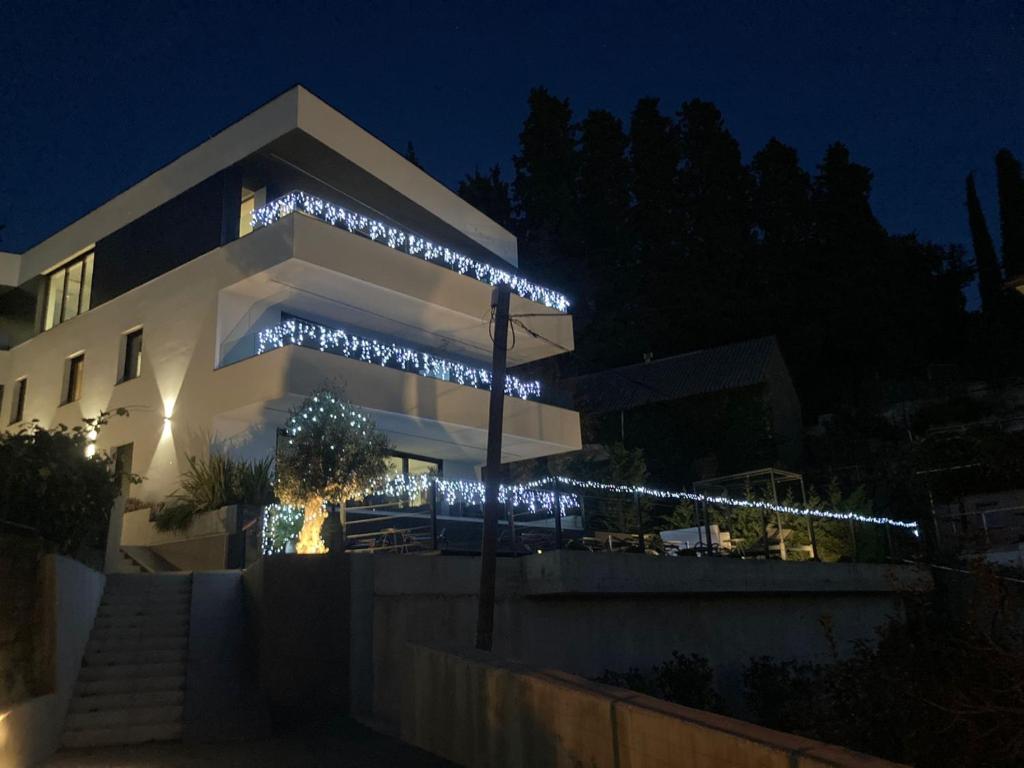 a building with christmas lights on it at night at Villa V in Rijeka