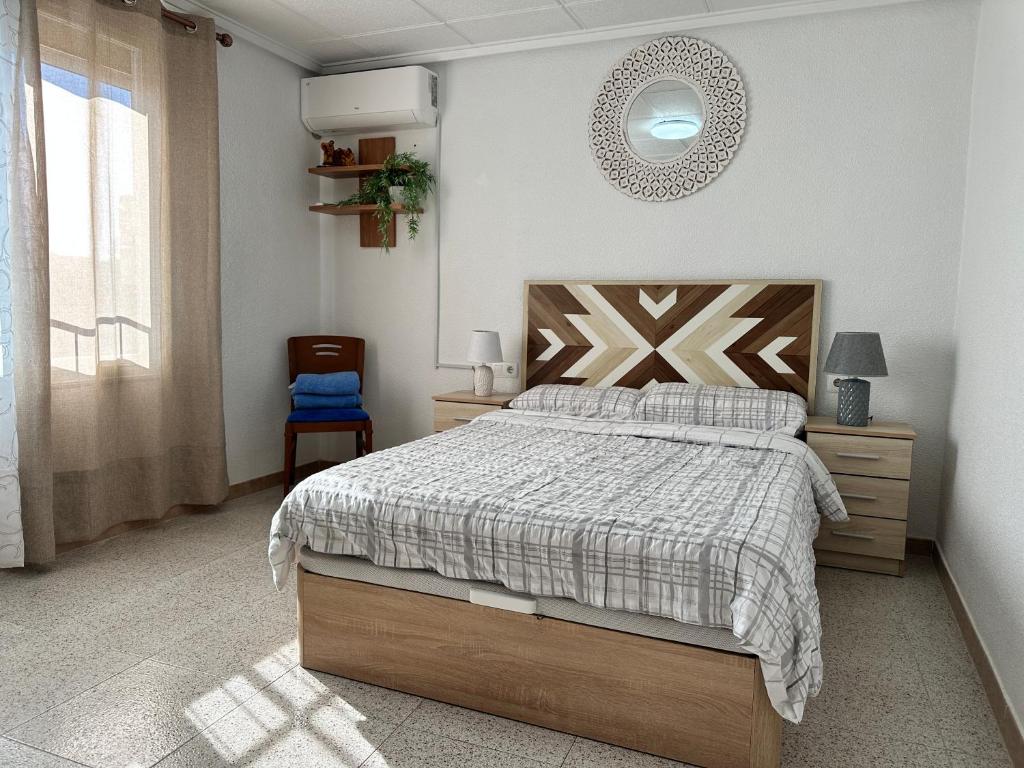 a bedroom with a bed and a mirror on the wall at Casa Angela de Novelda in Novelda