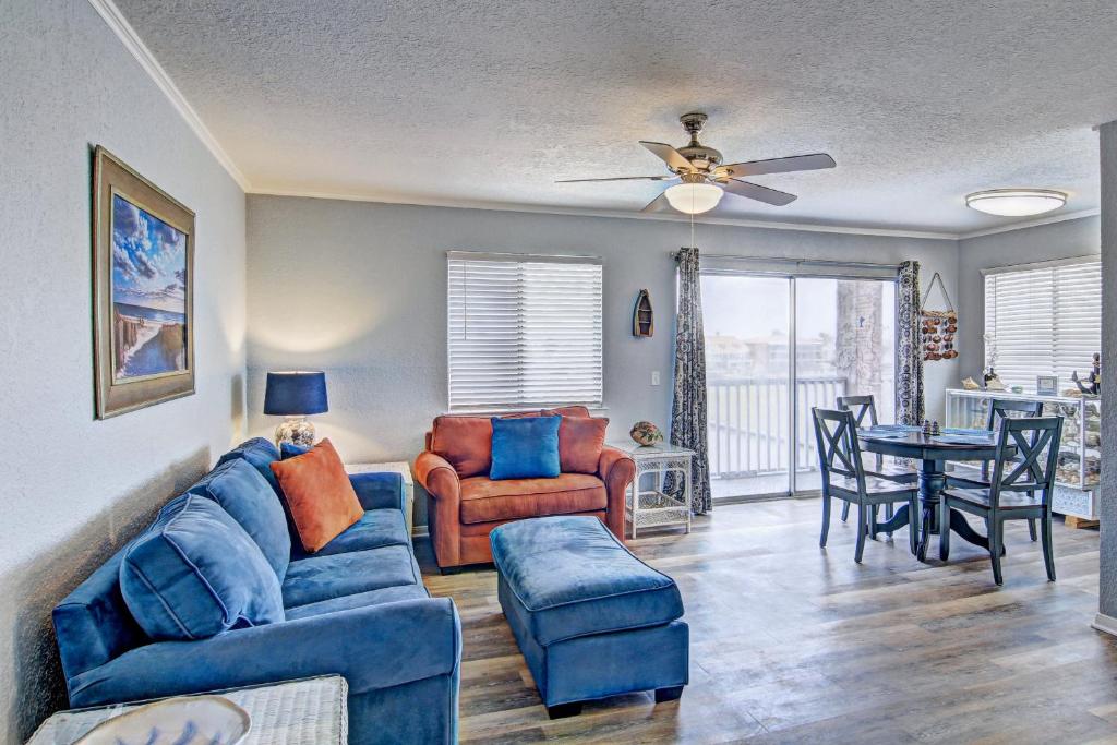 a living room with a couch and a table and chairs at Mystic Harbor 301 in Padre Island