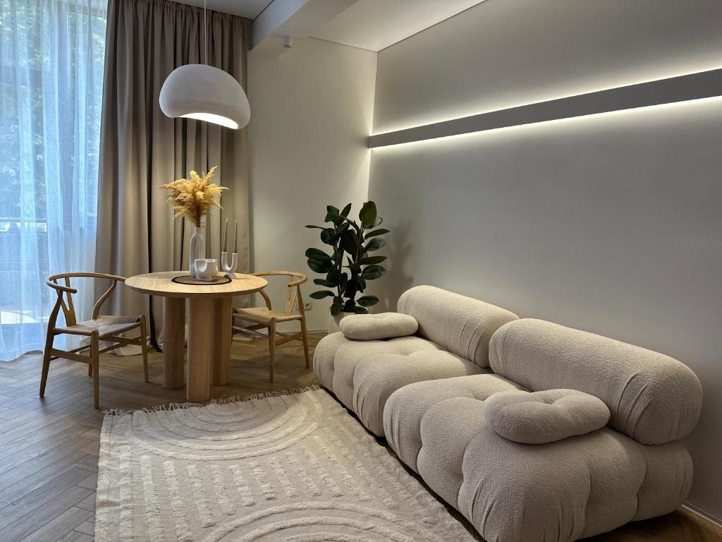 ein Wohnzimmer mit einem Sofa und einem Tisch in der Unterkunft Other Apartments in Iwano-Frankiwsk