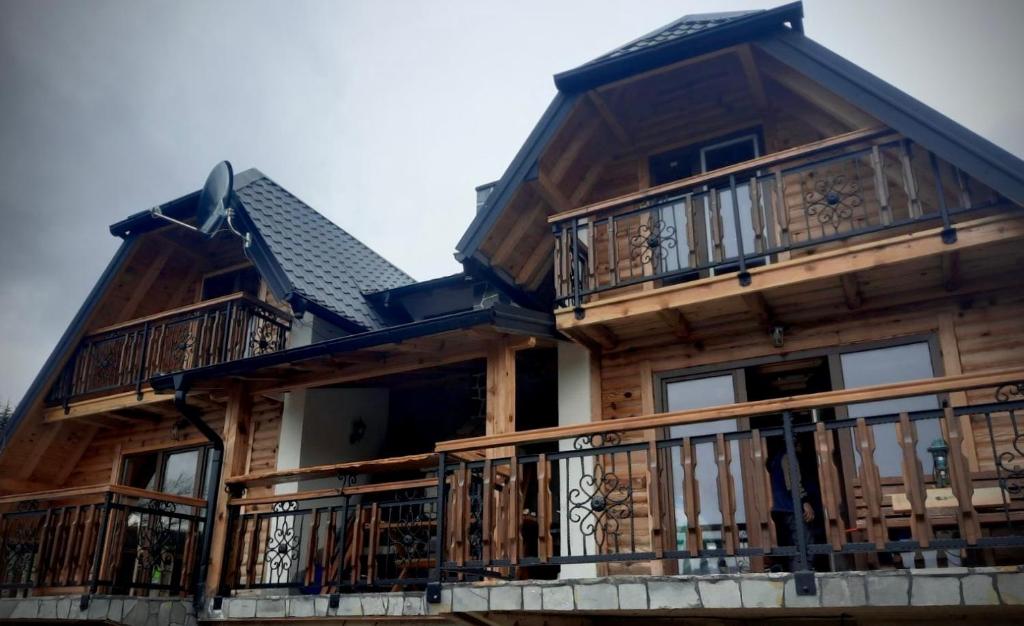 a large wooden house with balconies on it at Brvnara Pogled Zlatara in Nova Varoš