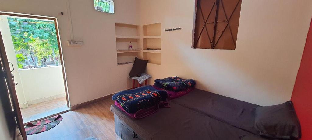 a living room with a couch and a window at Mahakaal HomeStay in Ujjain