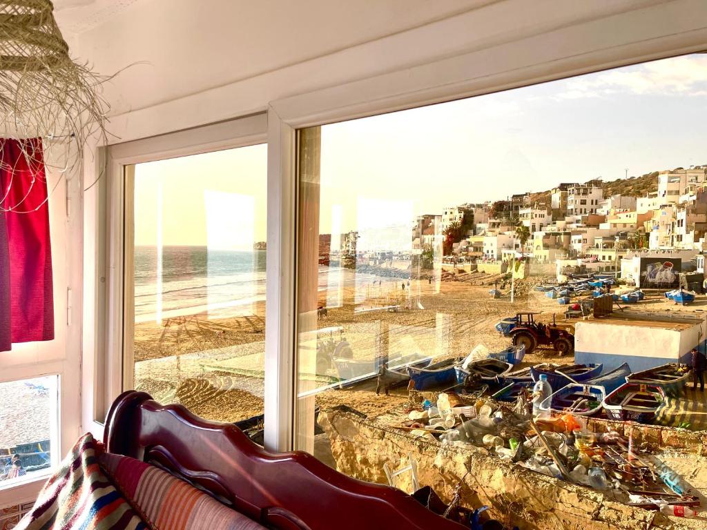 a room with a large window with a view of the beach at The Sea Guesthouse in Agadir