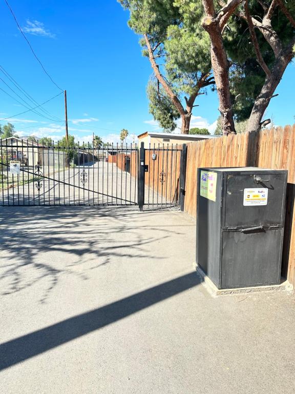 a black box sitting in front of a fence at Tiny house in the heart of MOVAL private freeparking Netflix in Moreno Valley