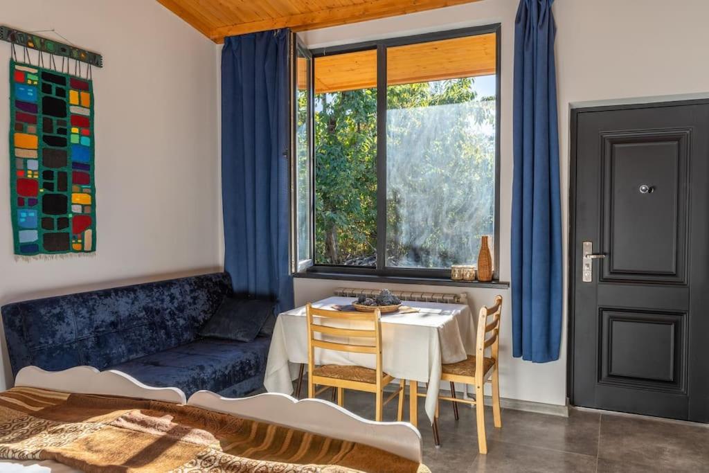 ein Wohnzimmer mit einem Tisch und einem Fenster in der Unterkunft Art Rooms Garni (Blue Edition) in Garni