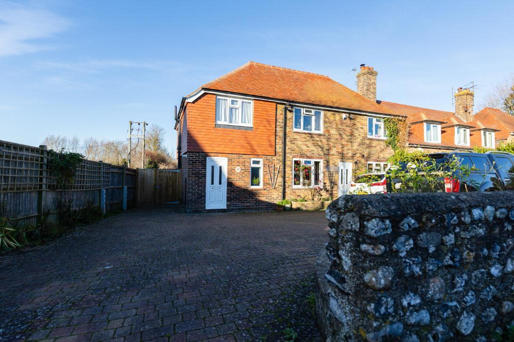 a large brick house with an orange roof at One Bridge End in Pevensey