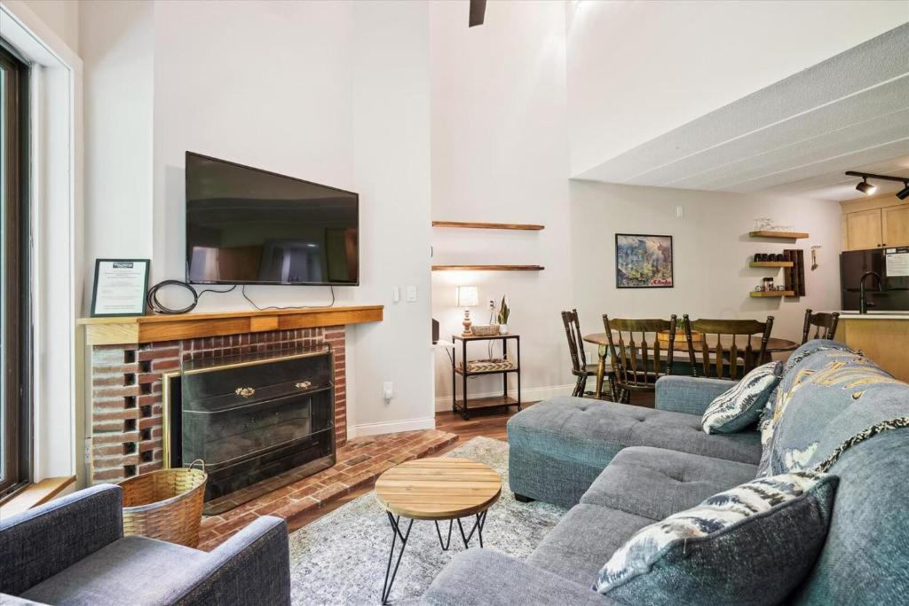 a living room with two couches and a fireplace at Pinnacle D17 in Killington