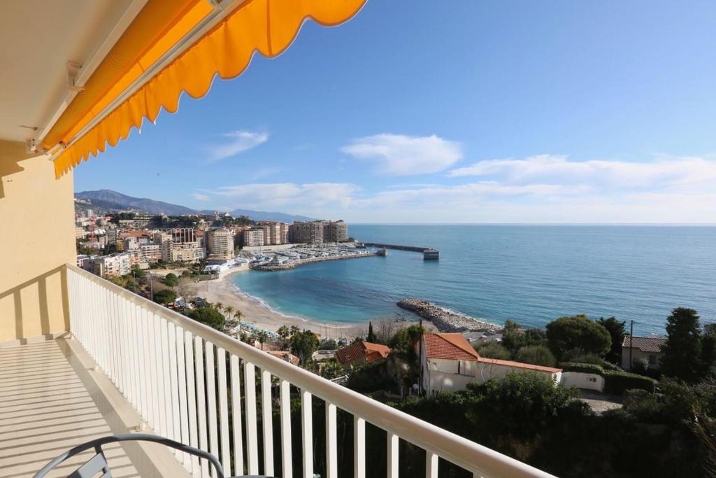 a balcony with a view of a beach and the ocean at BRIDGESTREET MONACO - cap d ail - roquebrune in Saint-Antoine