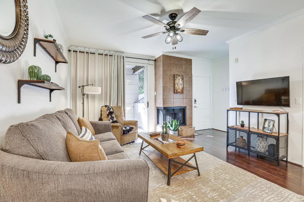 a living room with a couch and a table at Scottsdale Condo with Fireplace and Community Pools! in Scottsdale