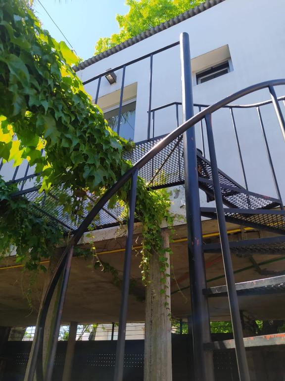 a spiral staircase in front of a building at depto muy cómodo en 1er piso in La Plata