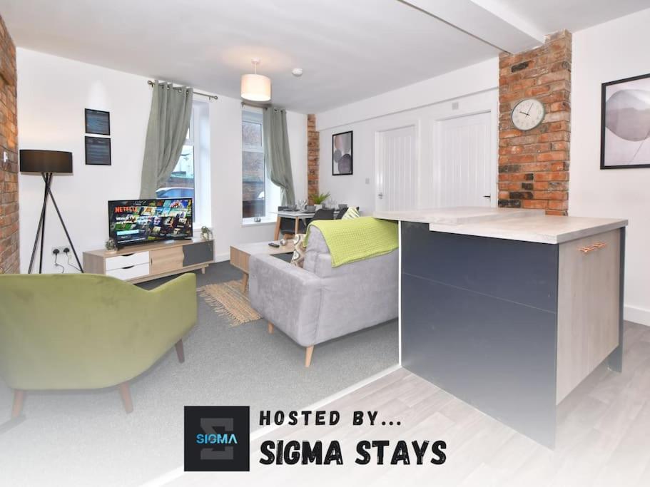 a living room with a kitchen and a living room with a couch at Lyndale House - By Sigma Stays in Crewe