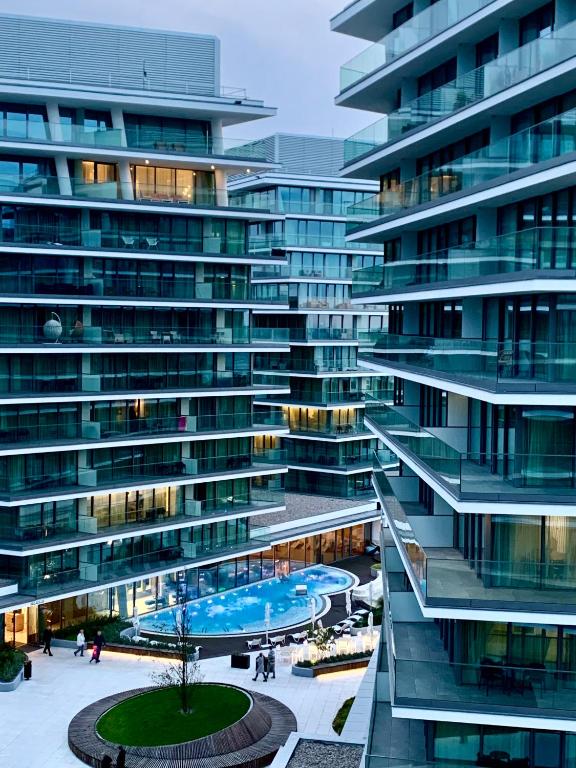 a large building with a swimming pool in front of it at Blue Reef 6th Floor Sea View in Międzyzdroje