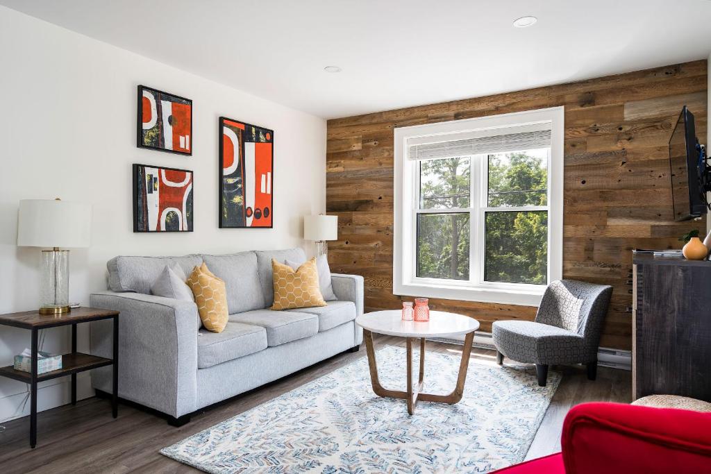 a living room with a couch and a table at "Ski" at Hills Meaford, Second Floor Suite w Bunk Beds in Meaford