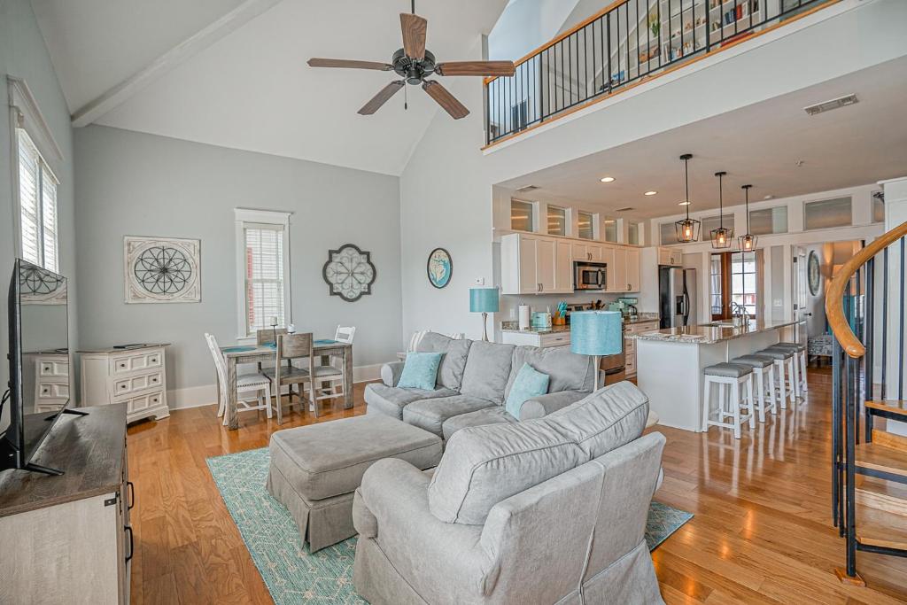 a large living room with a couch and a kitchen at Habersham Retreat on Abbey Row in Beaufort