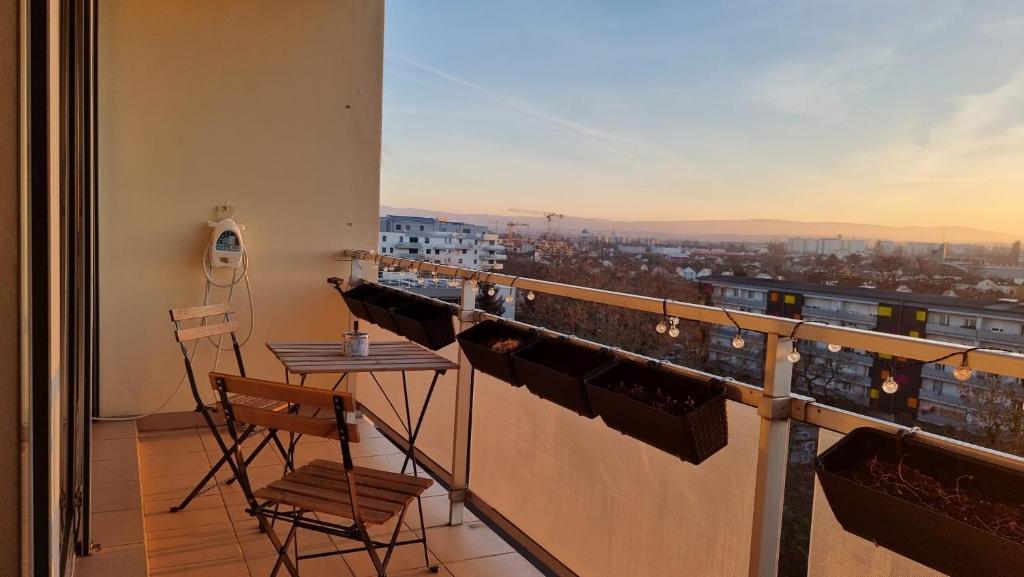 a balcony with a table and a view of a city at Dreamy Suite for Sunsetlovers in Saint-Louis