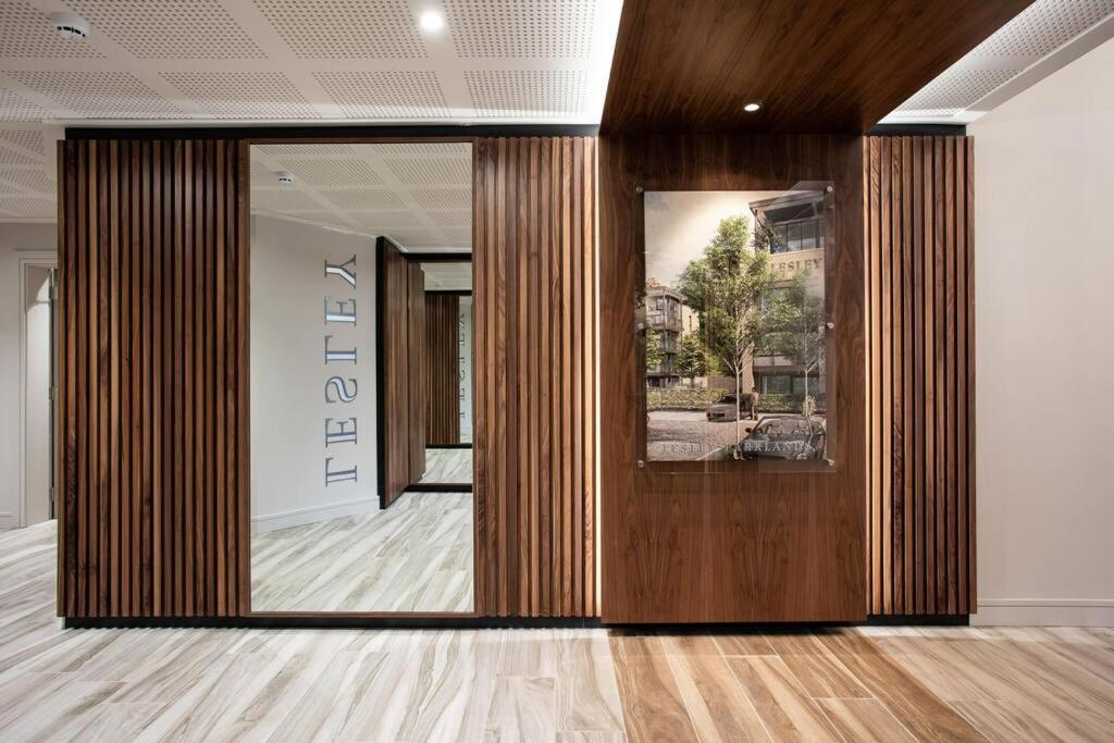a lobby with a wooden door in a building at Brand New, Luxury & with Terrace in Belfast