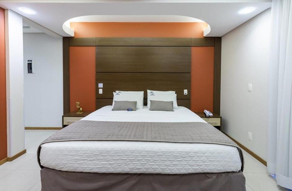 a bedroom with a large bed in a room at Centromar Hotel in Balneário Camboriú